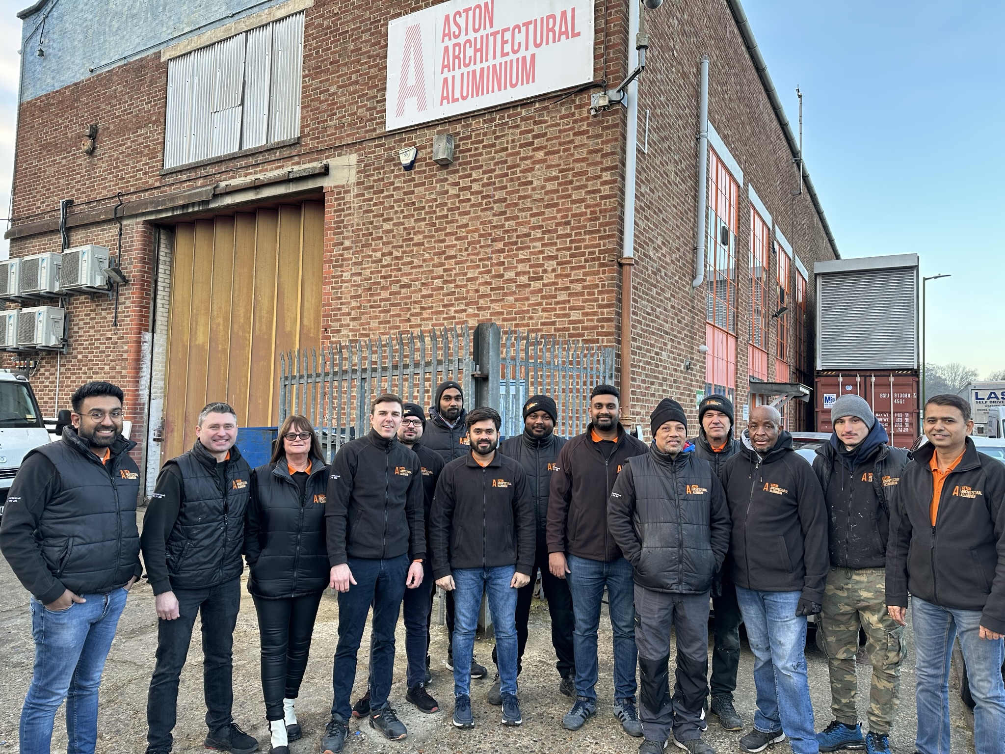 The team of Aston Architectural standing outside there factory.
